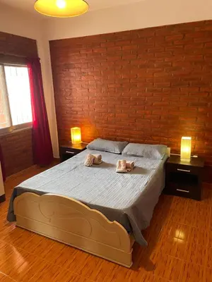 a bedroom with a bed with two towels on it at Areté Del Rio in Villa Carlos Paz