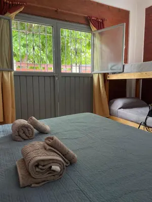 a bedroom with a bed with two towels on it at Areté Del Rio in Villa Carlos Paz