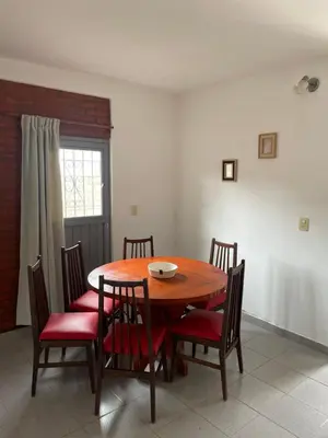 a dining room with a wooden table and chairs at Areté Del Rio in Villa Carlos Paz