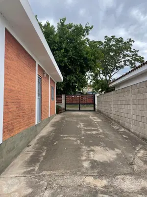 an empty parking lot next to a brick building at Areté Del Rio in Villa Carlos Paz