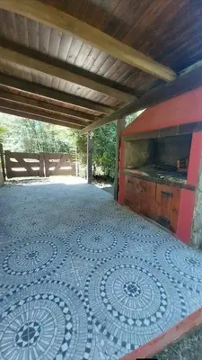 a patio with a tiled floor with a kitchen on it at Casas de alquiler villa ciudad parque in Villa Ciudad Parque