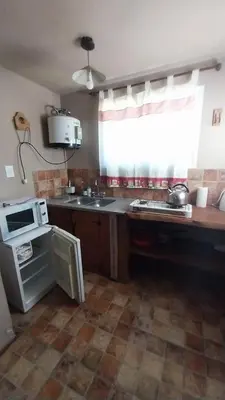 a kitchen with a counter and a sink and a window at Casas de alquiler villa ciudad parque in Villa Ciudad Parque