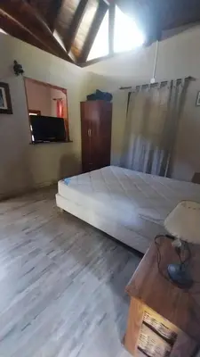 a bedroom with a bed and a table in it at Casas de alquiler villa ciudad parque in Villa Ciudad Parque