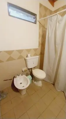 a bathroom with a toilet and a sink at Casas de alquiler villa ciudad parque in Villa Ciudad Parque