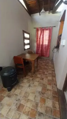 a room with a table and a chair and a table and a floor at Casas de alquiler villa ciudad parque in Villa Ciudad Parque