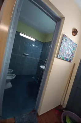 a bathroom with two toilets and a shower with a glass door at Complejo gauna in Villa Carlos Paz