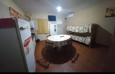 a room with a refrigerator and a table in it at Complejo gauna in Villa Carlos Paz