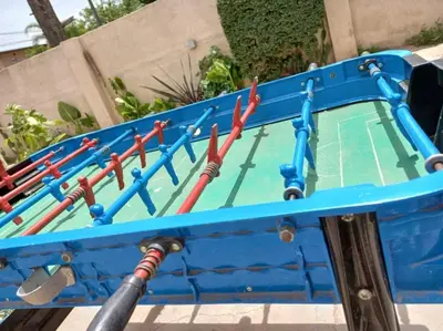 a blue cart filled with ping pong bats at Complejo gauna in Villa Carlos Paz