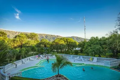 a swimming pool in a park with people in it at Complejo Kalinka in Carpintería
