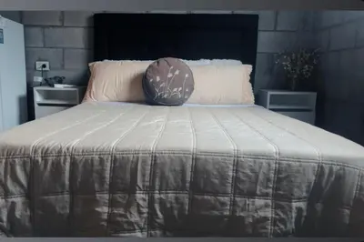 a bed with a blanket on top of it at Monoambiente luminoso y equipado, ubicado en zona céntrica in Cordoba
