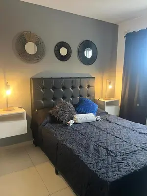 a bedroom with a large bed with two mirrors on the wall at Ruptura in Villa Carlos Paz
