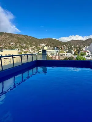 a large swimming pool with a view of a city at Ruptura in Villa Carlos Paz