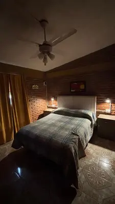 a bedroom with a bed and a ceiling fan at Departamento Vilma Planta Alta Brochero in Villa Cura Brochero