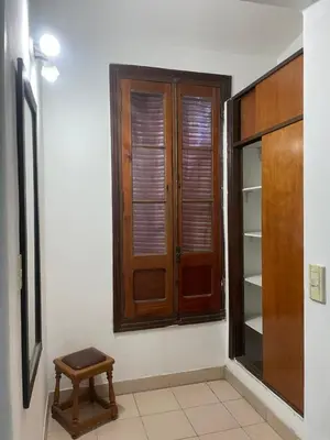 a room with a closet and a wooden window at Habitación Individual con todas las comodidades in Cordoba