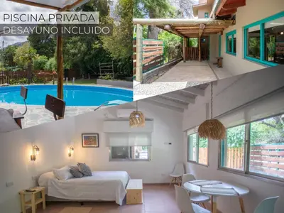 a villa with a pool and a bedroom and a living room at ASM Apart IX in Merlo