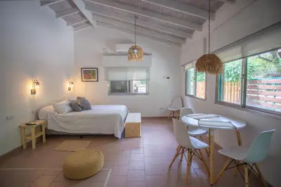 a bedroom with a bed and a table and chairs at ASM Apart IX in Merlo