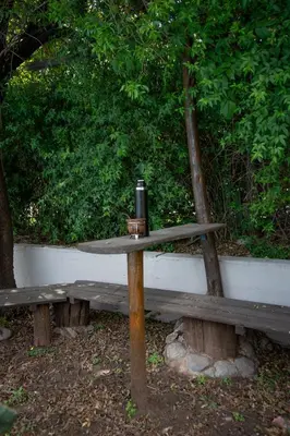 a wooden bench with a bottle on top of it at ASM Apart IX in Merlo