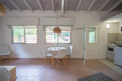 a kitchen and dining room with a table and chairs at ASM Apart IX in Merlo
