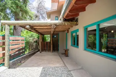 a entrance to a house with a wooden pergola at ASM Apart IX in Merlo