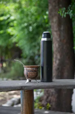 a black thermos sitting on top of a wooden table at ASM Apart IX in Merlo