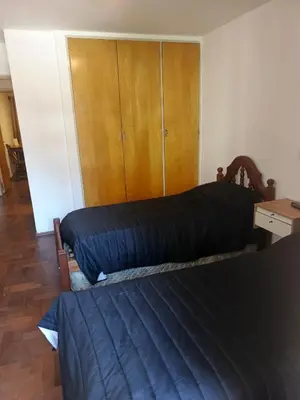 a bedroom with two beds and a closet at departamento velez 372 in Cordoba
