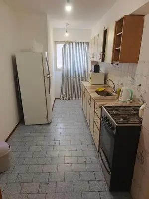 a kitchen with a refrigerator and a stove top oven at departamento velez 372 in Cordoba
