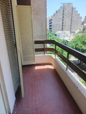 a balcony with a door and a brick floor at departamento velez 372 in Cordoba
