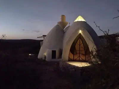 a small white dome home with a lit up window at Cabañas Las Luciérnagas in San Javier