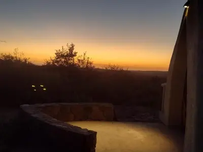 a sunset view from the outside of a building at Cabañas Las Luciérnagas in San Javier