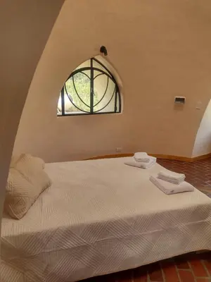 a bedroom with a large bed with a window at Cabañas Las Luciérnagas in San Javier