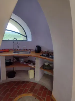 a kitchen with a sink and an arched window at Cabañas Las Luciérnagas in San Javier