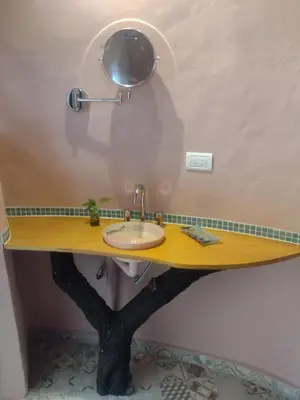 a bathroom with a wooden counter with a sink at Cabañas Las Luciérnagas in San Javier