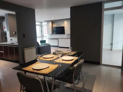 a dining room with a black table and chairs at Comfort and Location in Río Cuarto