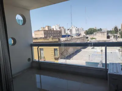 a room with a large window with a view of a city at Comfort and Location in Río Cuarto