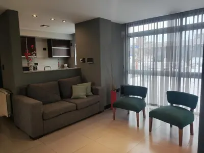 a living room with a couch and two chairs at Comfort and Location in Río Cuarto