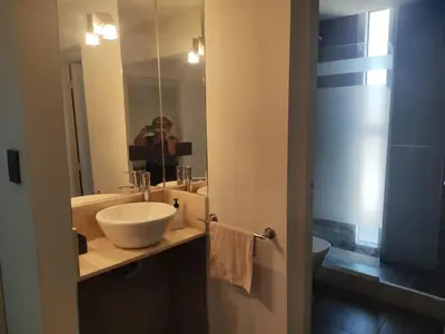 a person taking a picture of a bathroom with a sink at Comfort and Location in Río Cuarto