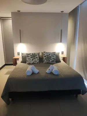 a bedroom with a bed with two towels on it at Comfort and Location in Río Cuarto