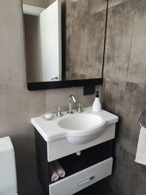 a bathroom with a sink and a mirror at Comfort and Location in Río Cuarto