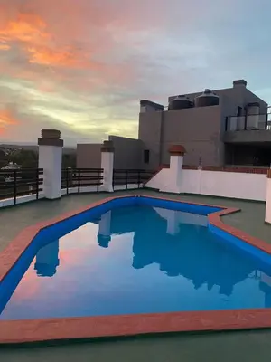 a swimming pool on the roof of a house at Departamento con inmejorable ubicacion en Villa Carlos Paz in Villa Carlos Paz