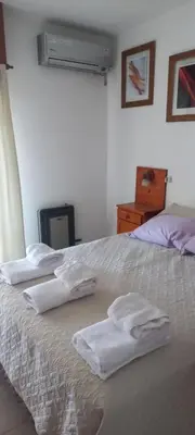 a bedroom with three white towels on a bed at Departamento con inmejorable ubicacion en Villa Carlos Paz in Villa Carlos Paz