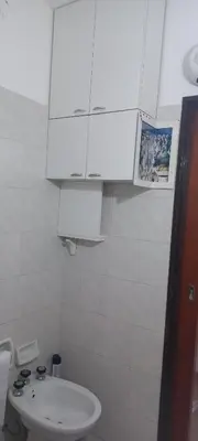 a white bathroom with a sink and a cabinet at Departamento con inmejorable ubicacion en Villa Carlos Paz in Villa Carlos Paz
