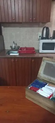 a kitchen counter with a sink and a microwave at Departamento con inmejorable ubicacion en Villa Carlos Paz in Villa Carlos Paz