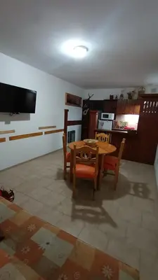 a kitchen and dining room with a table and chairs at Departamento con inmejorable ubicacion en Villa Carlos Paz in Villa Carlos Paz