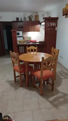 a wooden table and chairs in a kitchen at Departamento con inmejorable ubicacion en Villa Carlos Paz in Villa Carlos Paz