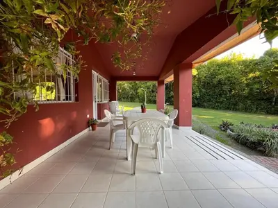 a patio with a white table and chairs on it at Rocco Housse in Los Hornillos