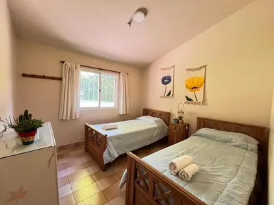 a bedroom with two beds and a window at Rocco Housse in Los Hornillos