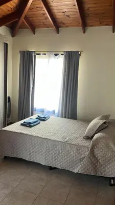 a bedroom with a large bed with a window at Shakti in Almafuerte