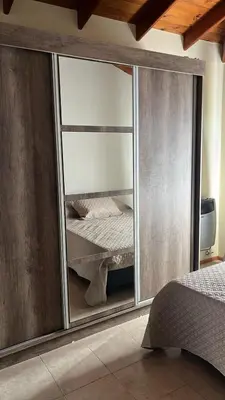 a bedroom with a mirrored closet with a bed in it at Shakti in Almafuerte