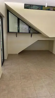 an empty room with a staircase and a tile floor at Shakti in Almafuerte