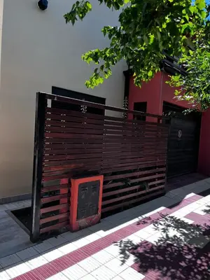 a wooden fence in front of a building at Shakti in Almafuerte